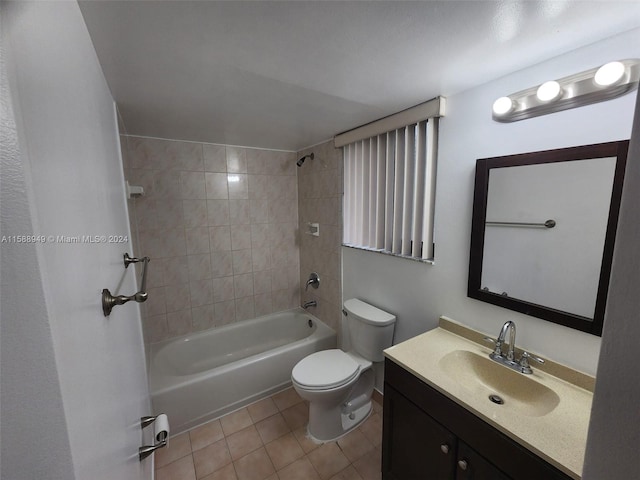 full bathroom featuring tile patterned floors, toilet, tiled shower / bath, and vanity