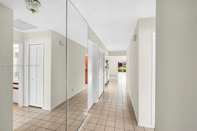 hall featuring light tile patterned floors