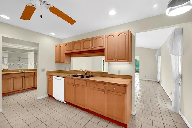 kitchen featuring light tile patterned flooring, dishwasher, sink, and ceiling fan