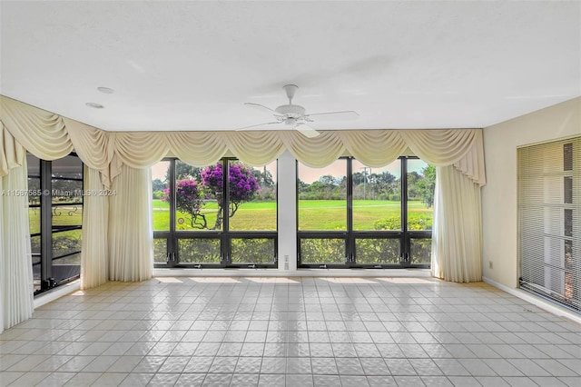 unfurnished room featuring ceiling fan and light tile patterned floors