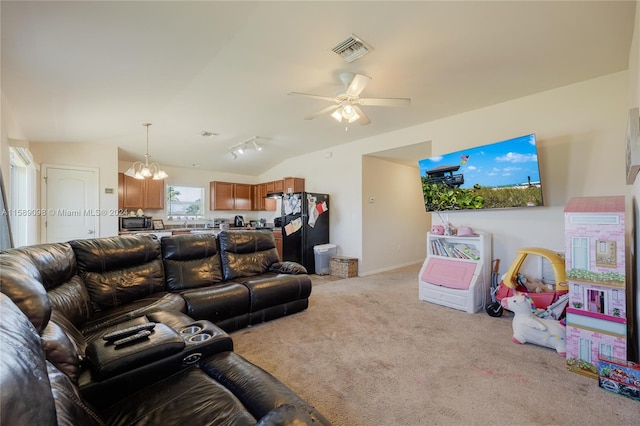 carpeted living room with vaulted ceiling and ceiling fan with notable chandelier