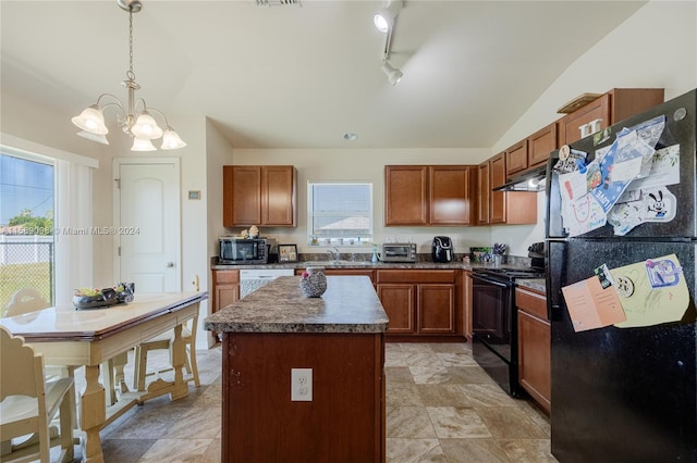 kitchen featuring black appliances, plenty of natural light, a kitchen island, and rail lighting