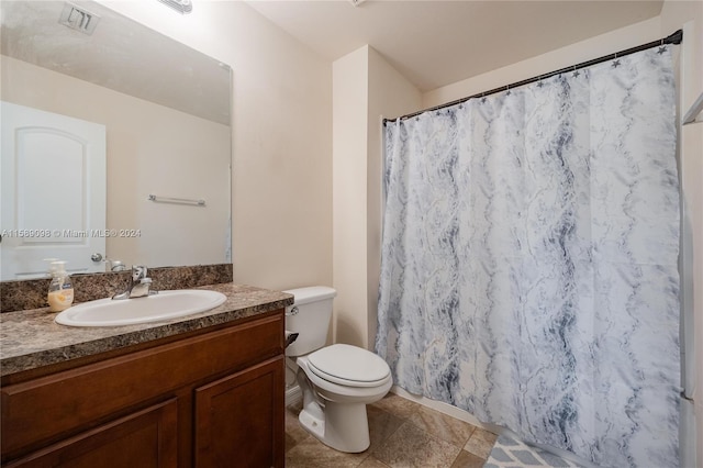 bathroom with tile flooring, vanity, and toilet