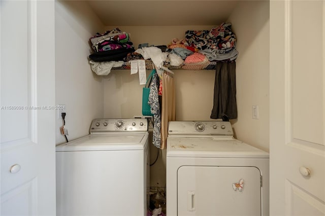 clothes washing area featuring washer and clothes dryer