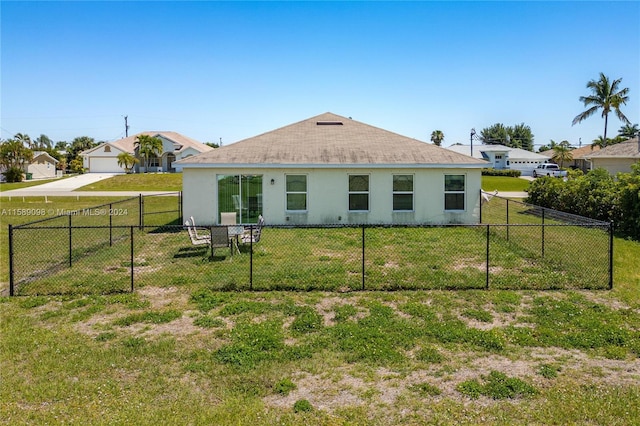 back of house featuring a yard