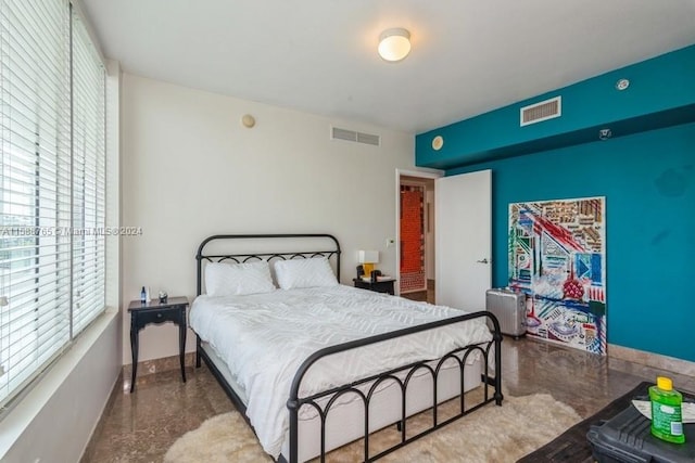 bedroom featuring concrete flooring