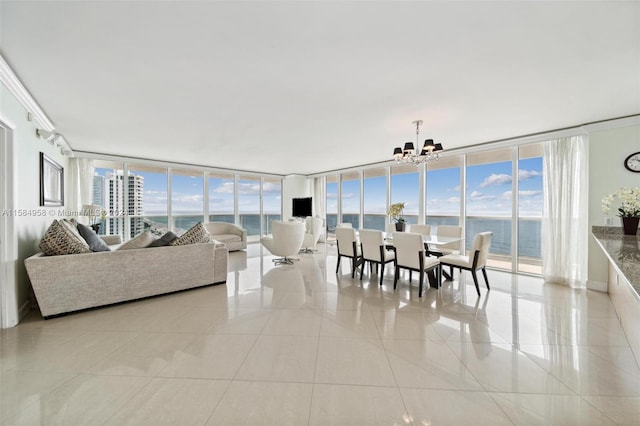 interior space with an inviting chandelier, a wealth of natural light, a water view, and light tile floors