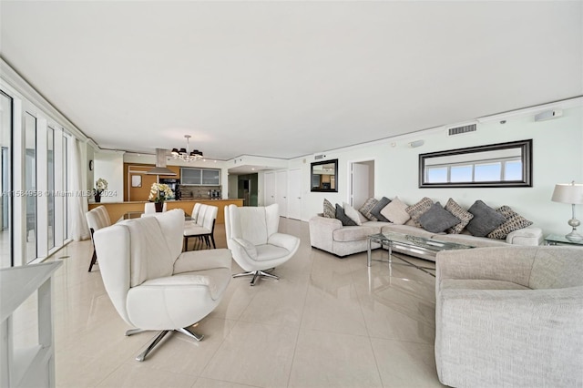 living room with a notable chandelier and light tile flooring