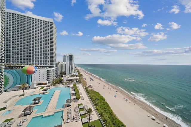 birds eye view of property with a beach view and a water view