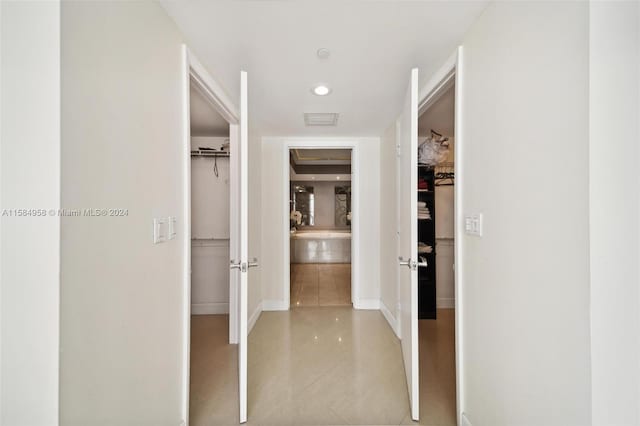 hallway with tile flooring