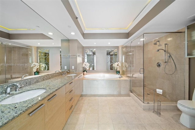 full bathroom featuring independent shower and bath, double sink vanity, a raised ceiling, tile floors, and toilet