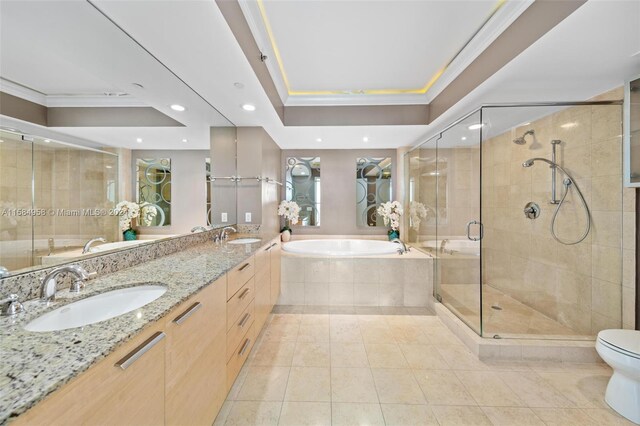 full bathroom with shower with separate bathtub, tile floors, dual vanity, toilet, and a raised ceiling