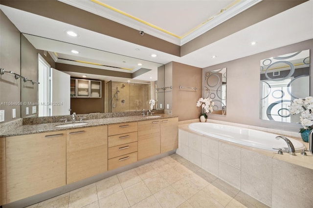 bathroom featuring a tray ceiling, double vanity, tiled tub, tile floors, and ornamental molding