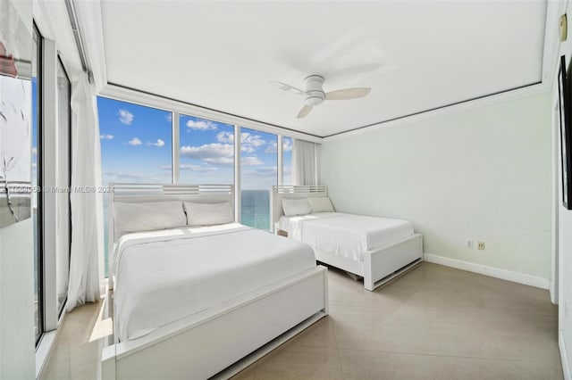 bedroom featuring ceiling fan, crown molding, a water view, and light tile floors