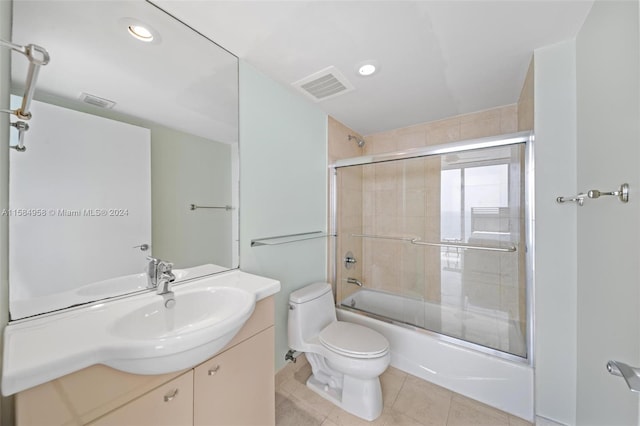 full bathroom with shower / bath combination with glass door, tile flooring, oversized vanity, and toilet