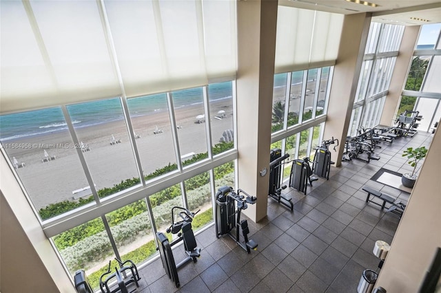 balcony featuring a beach view and a water view