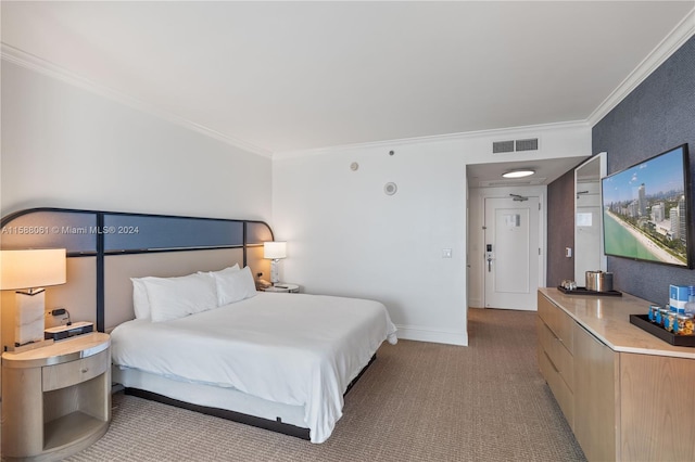 bedroom with ornamental molding and dark colored carpet