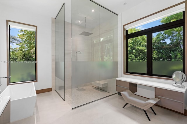 bathroom with separate shower and tub and plenty of natural light