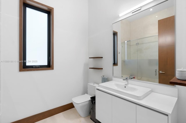 bathroom featuring tile patterned floors, vanity, a shower with shower door, and toilet