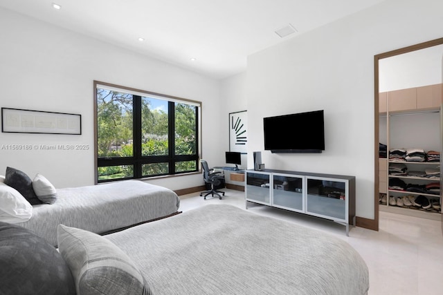 bedroom featuring a walk in closet