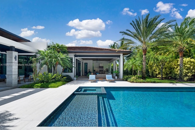 view of swimming pool with ceiling fan and a patio area