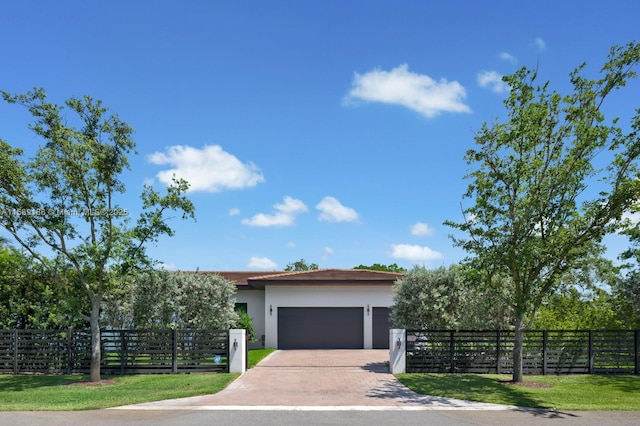 view of front facade with a front lawn and a garage