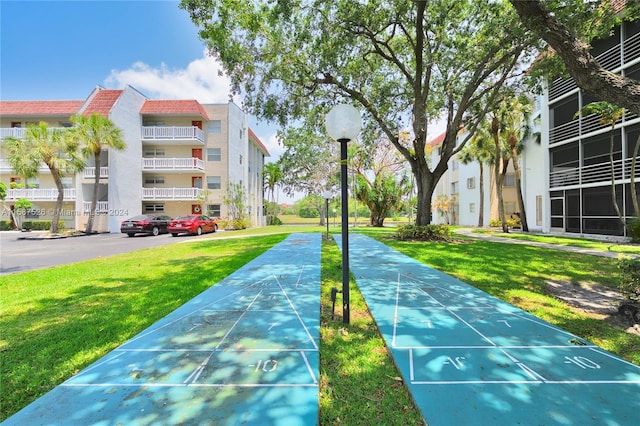 view of home's community with a lawn