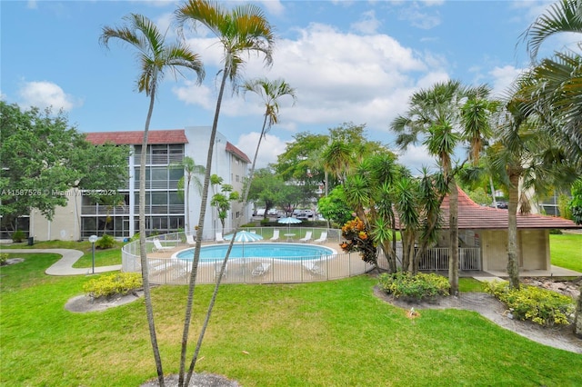 view of pool featuring a lawn