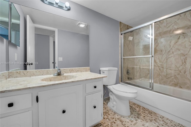 full bathroom with tile patterned flooring, vanity, toilet, and shower / bath combination with glass door