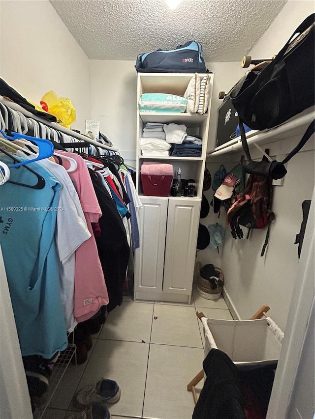 walk in closet featuring tile flooring