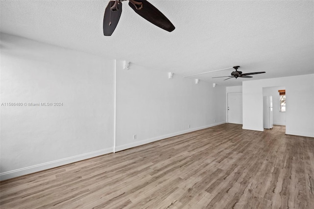 unfurnished living room with hardwood / wood-style floors, ceiling fan, and a textured ceiling