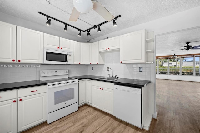 kitchen with backsplash, ceiling fan, track lighting, sink, and white appliances