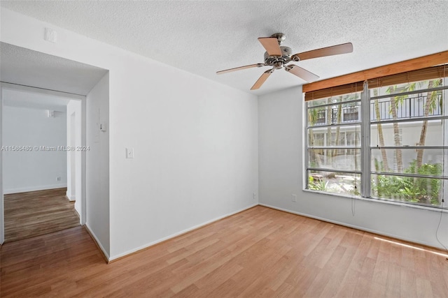 spare room featuring a textured ceiling, ceiling fan, and hardwood / wood-style floors