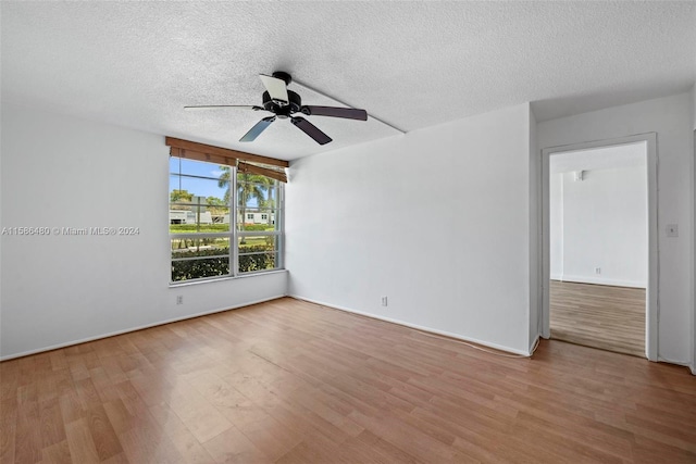 spare room with ceiling fan, hardwood / wood-style flooring, and a textured ceiling