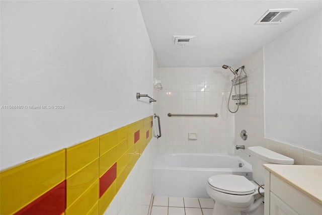 full bathroom featuring tile flooring, tile walls, toilet, and tiled shower / bath combo