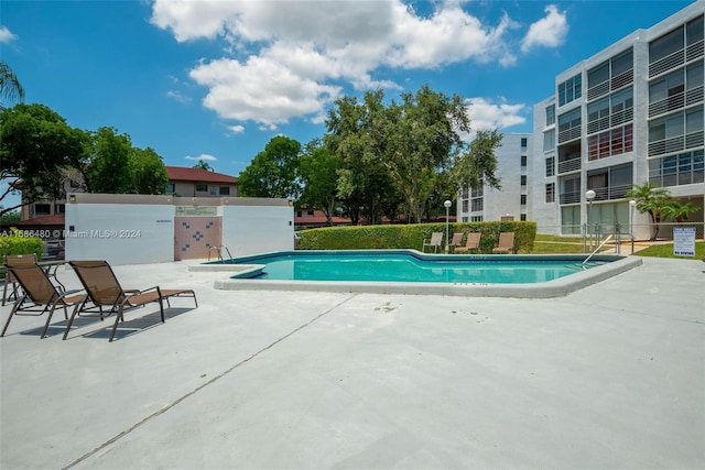 view of swimming pool featuring a patio area