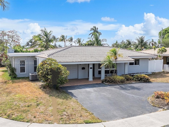 view of front of home with a garage and central AC unit