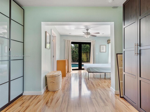 bedroom with access to outside, ceiling fan, french doors, and light wood-type flooring