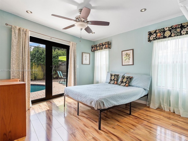 bedroom with french doors, access to outside, ceiling fan, and light hardwood / wood-style floors