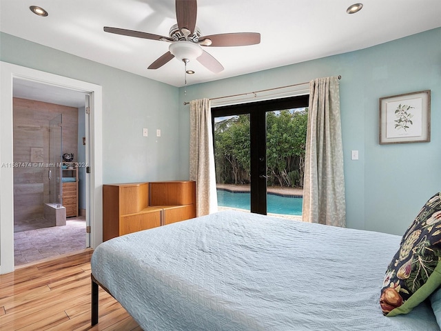 bedroom with ceiling fan, french doors, ensuite bathroom, access to outside, and hardwood / wood-style flooring