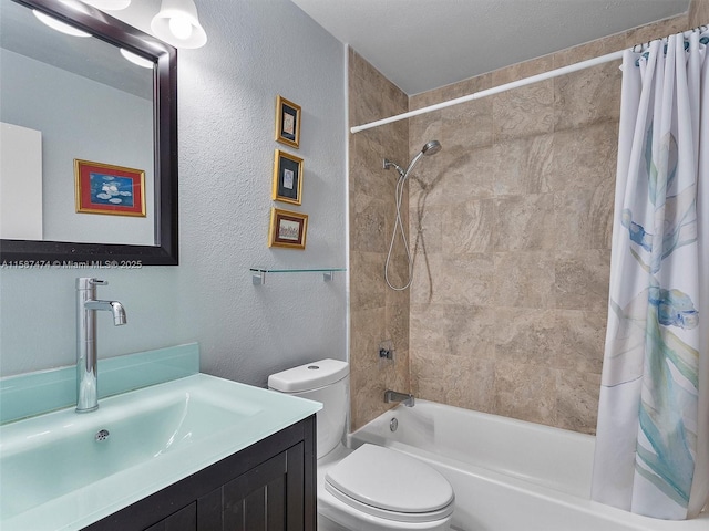 bathroom with shower / tub combo, a textured wall, vanity, and toilet