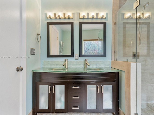 bathroom featuring vanity and a shower with door