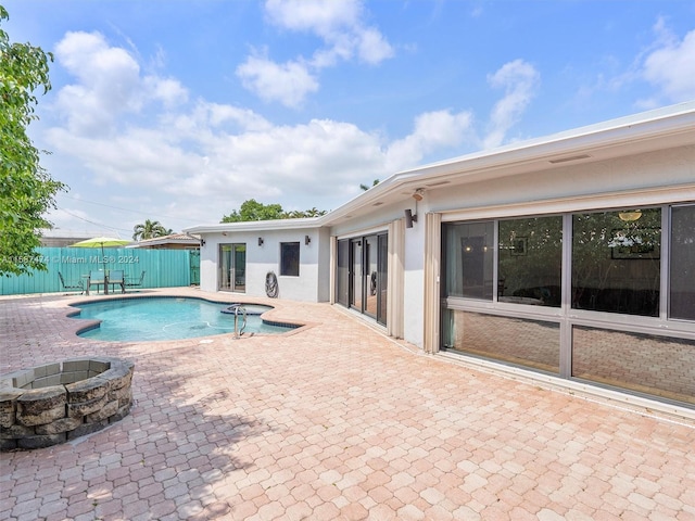 view of pool featuring a patio area and an outdoor fire pit