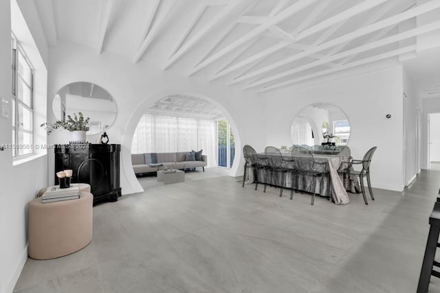 dining room featuring tile floors and beam ceiling