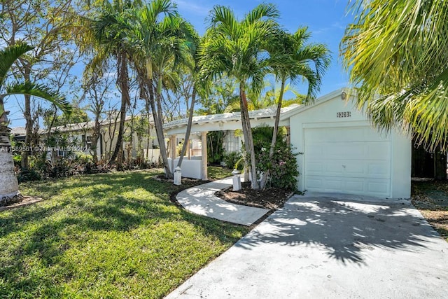 view of front of house featuring a garage and a front lawn