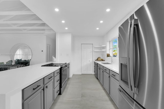 kitchen featuring sink, gray cabinets, light tile flooring, and stainless steel appliances