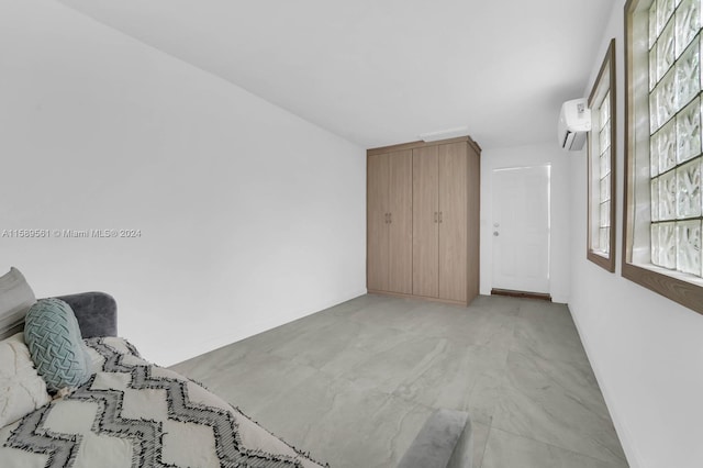 unfurnished bedroom featuring a wall mounted air conditioner and multiple windows