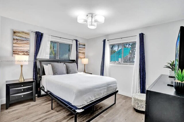 bedroom featuring hardwood / wood-style floors, ceiling fan, and a closet