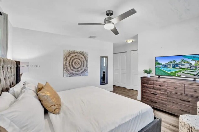 bedroom with light wood-type flooring and ceiling fan