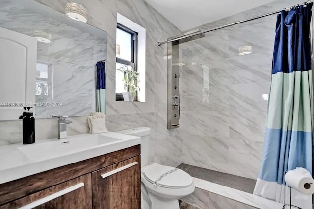 bathroom with a shower with shower curtain, vanity, toilet, and tile walls